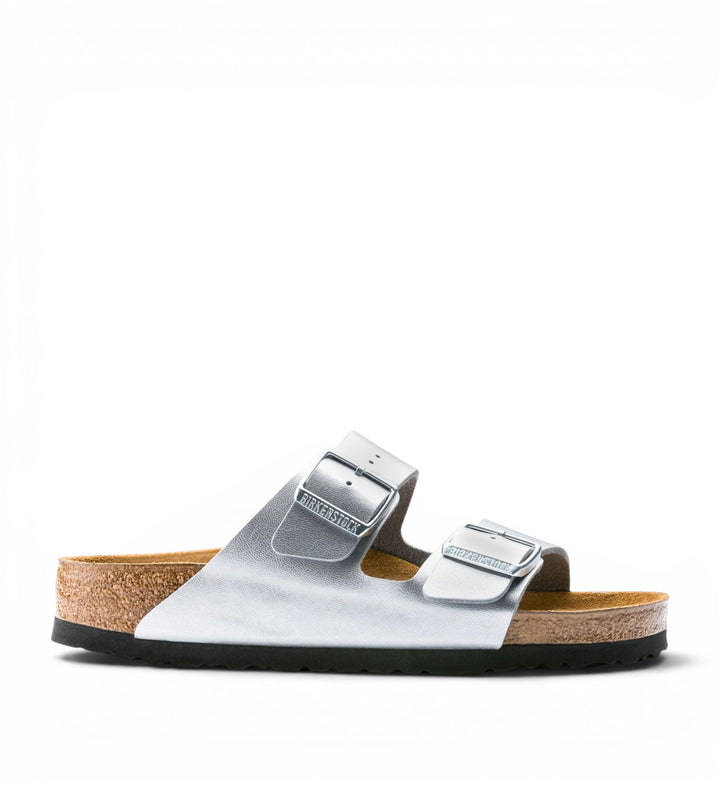 Birkenstock Arizona Birko-Flor metallic silver double-strap sandals with adjustable buckles and cork footbed.