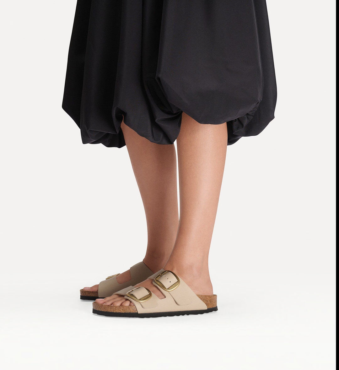 House of Florian Arizona Big Buckle sandals in sandcastle Birko-Flor with gold buckles worn with a black skirt