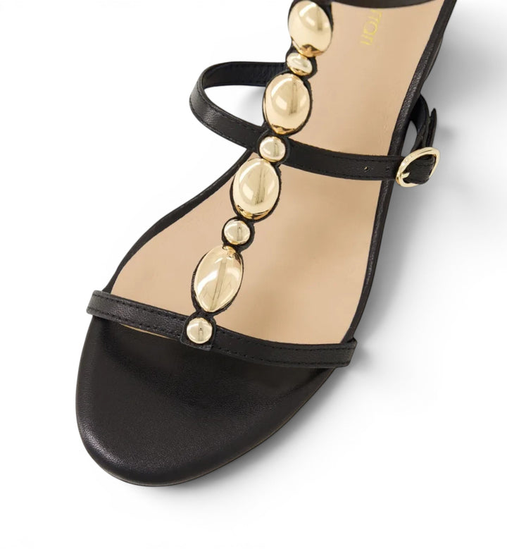 House of Florian Glimery black leather sandal with gold-tone metallic bead embellishments and an ankle strap.