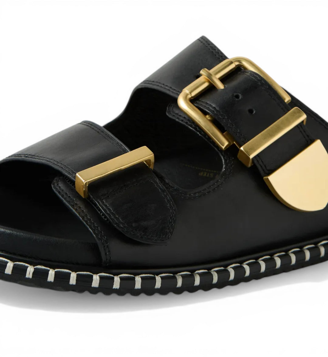 House of Florian Iyami W black leather sandals with gold buckle details and decorative stitching.