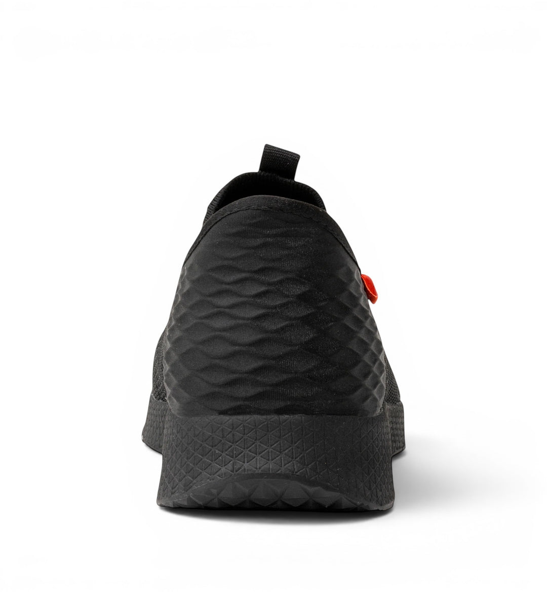 House of Florian black slip-on shoe with textured upper and rubber sole. Features a pull tab and orange accent.