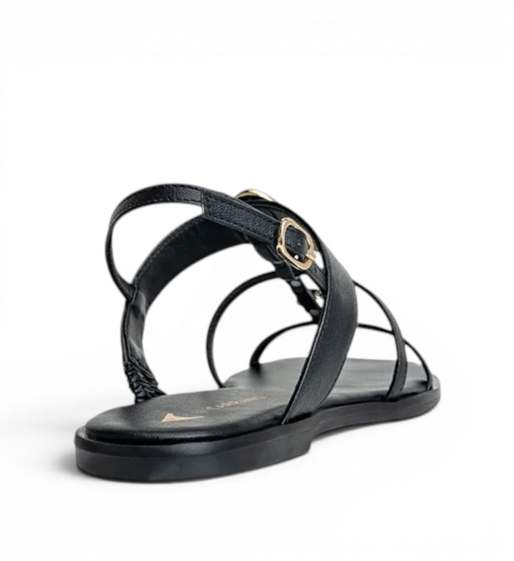 House of Florian black leather strappy flat sandals with gold buckle detail.