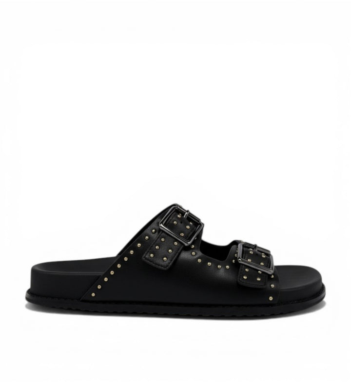House of Florian black leather slide sandals with double buckle straps and gold stud detailing.