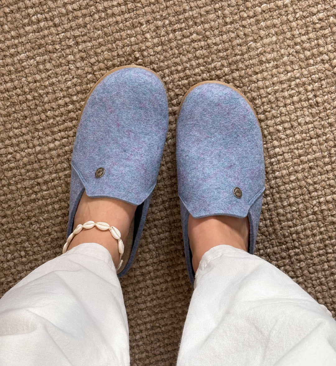 House of Florian DR. FEET Hoops blue marle wool felt mule slippers worn on a carpeted floor with white trousers.