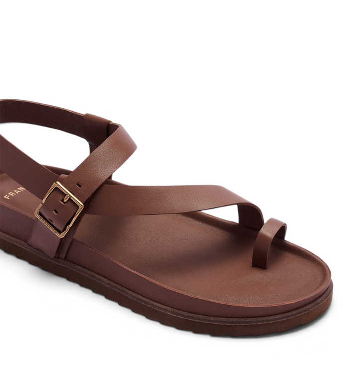 House of Florian Ren Cinnamon brown leather toe-loop sandal with an adjustable ankle strap and gold buckle.