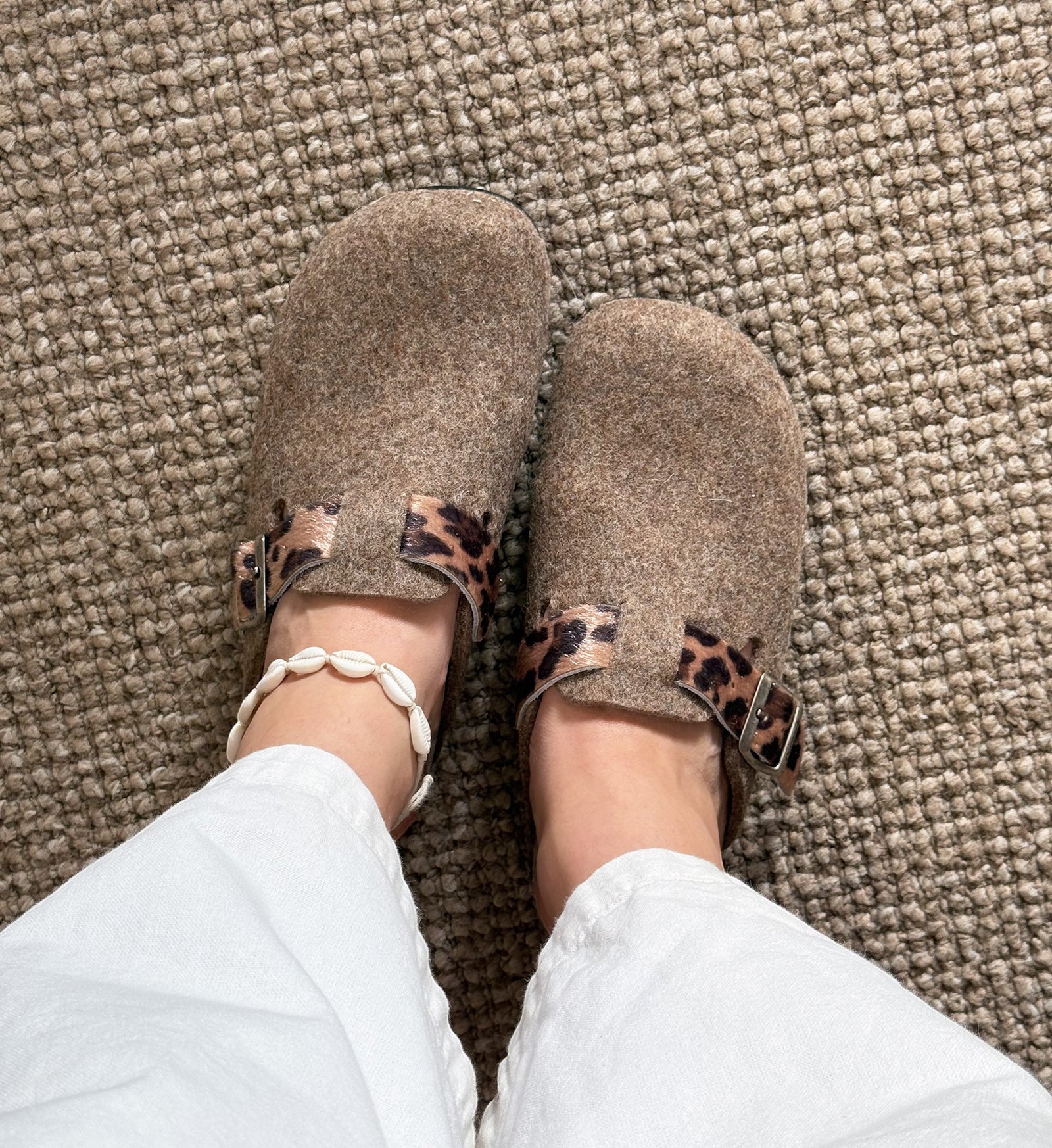House of Florian Dr Feet  honey camel felt clogs with leopard print strap detail worn with white trousers and shell anklet