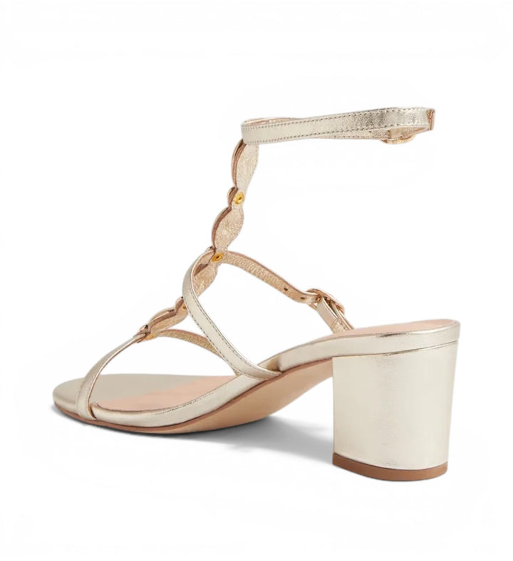 House of Florian Glimery Gold metallic block heel sandals with a delicate t-strap design and ankle buckle closure.