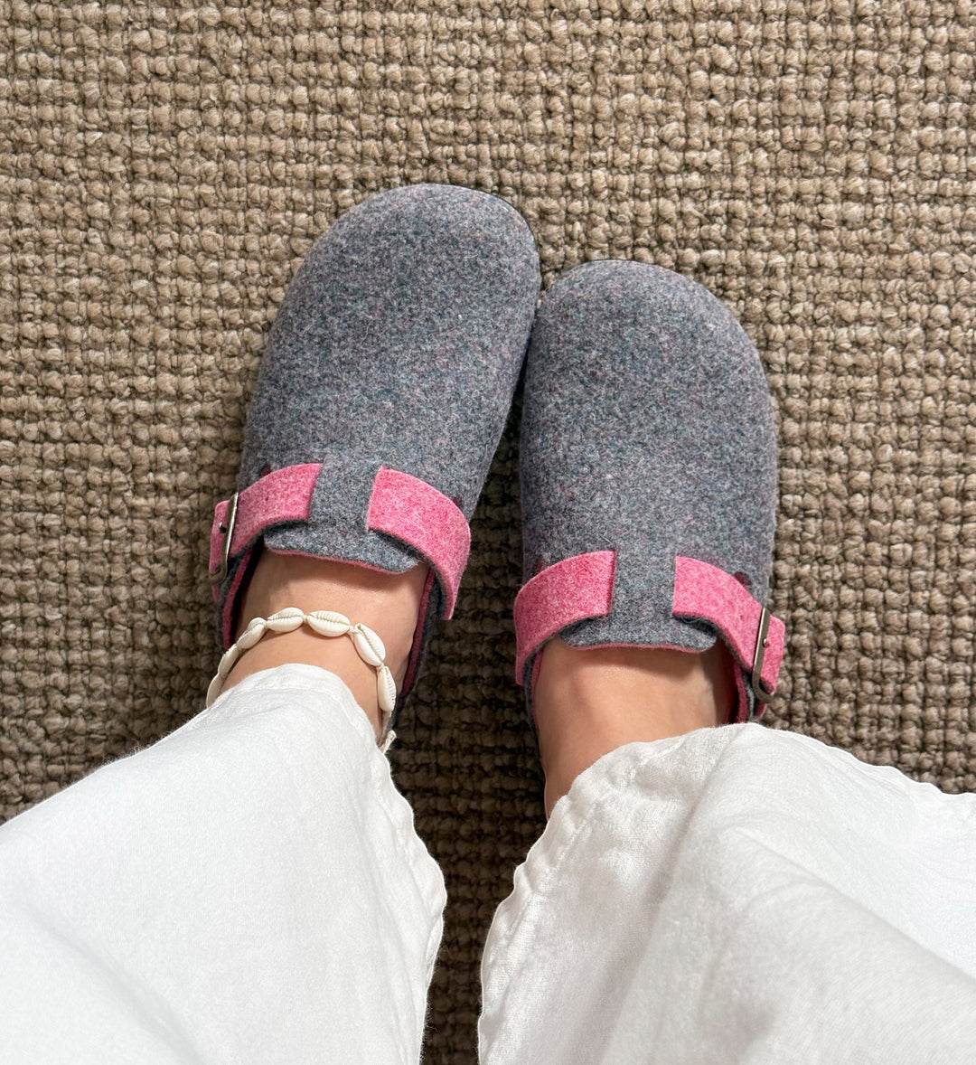 House of Florian Honey Heather Combo felt clogs in grey with pink adjustable straps worn with white trousers