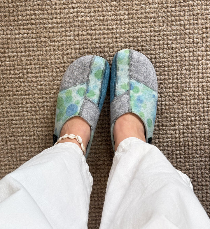 House of Florian DR. FEET Hilda wool felt slippers in blue bubbles pattern worn with white trousers on carpet