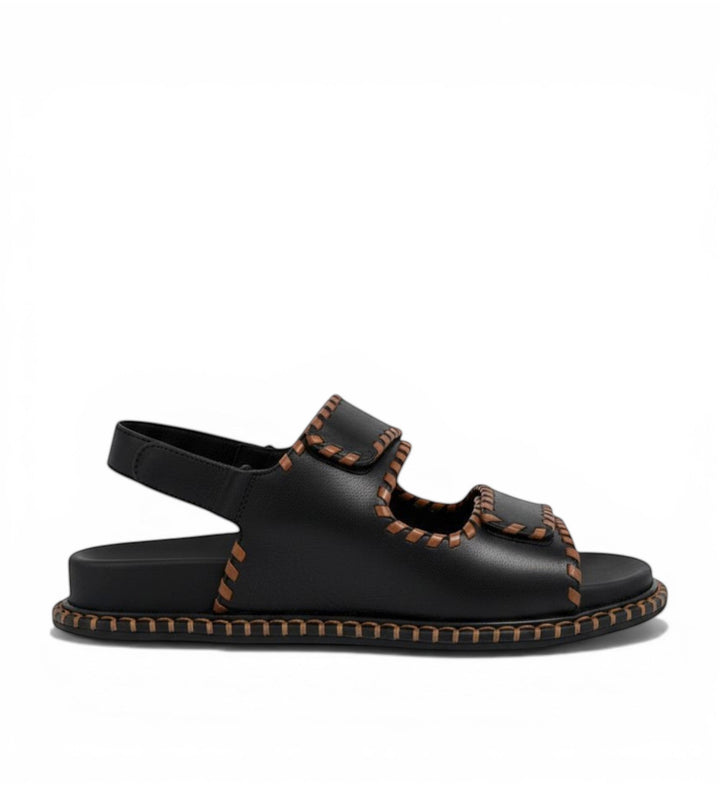 House of Florian Ihazil W black leather sandals with tan contrast stitching and adjustable straps.