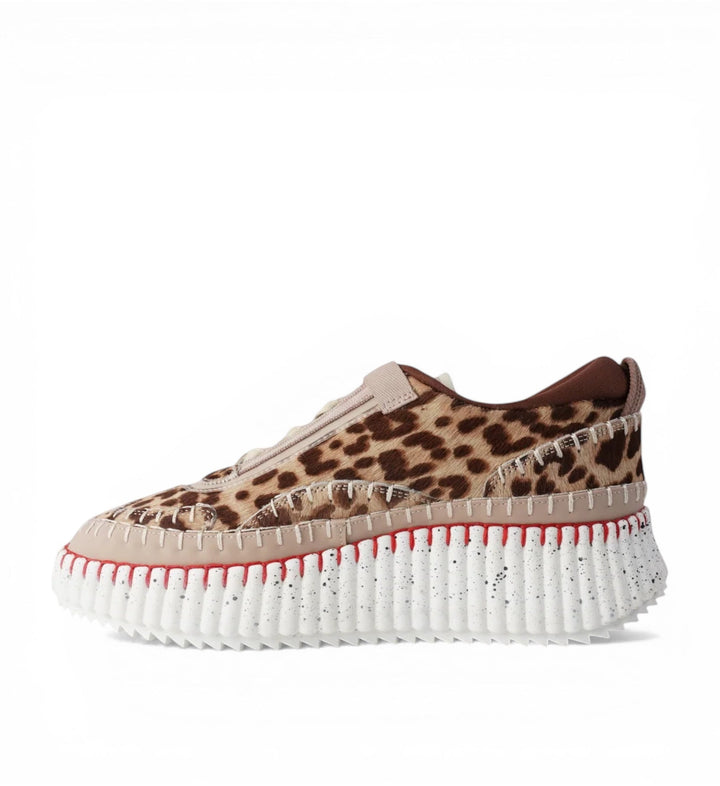 House of Florian Copen Leopard platform sneakers with leopard print pony hair and beige leather accents, featuring red stitching and a white speckled sole.