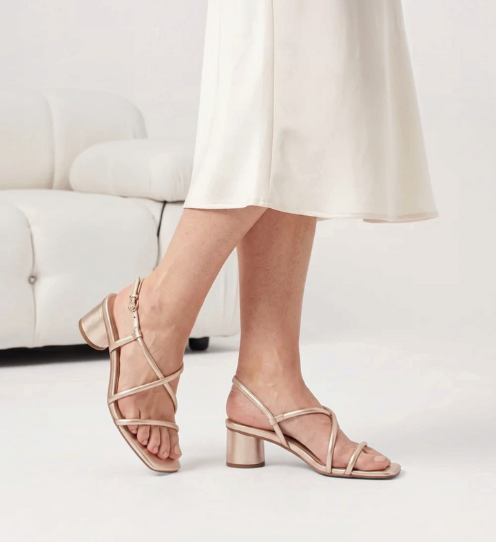 House of Florian Lottie soft gold strappy block heel sandals with an adjustable ankle strap on a model