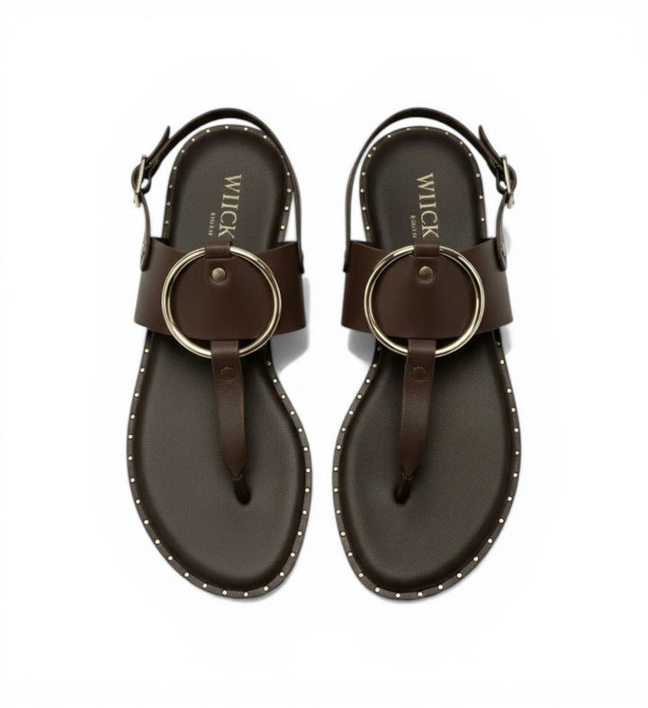 House of Florian Tegan maroon leather flat sandals with gold ring detail and stud trim.