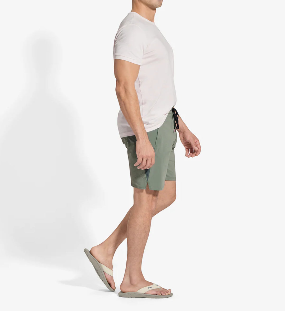 House of Florian Ohana Mens Tapa Clay shorts with a light pink t-shirt and flip-flops.
