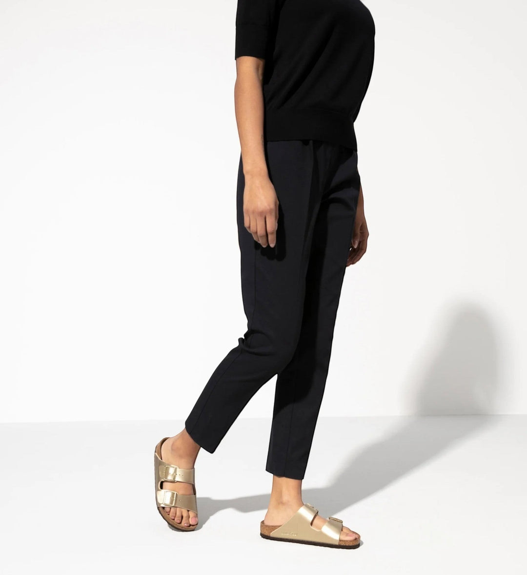 House of Florian Arizona Birko-Flor metallic gold double-strap sandals with cork footbed on a woman.