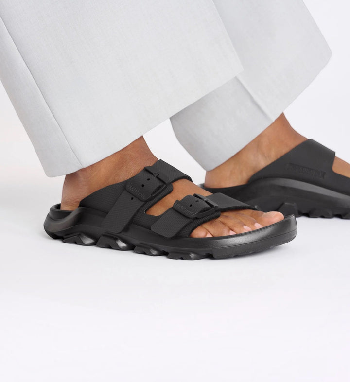 House of Florian Mogami Terra black two-strap sandals with rugged soles worn with light trousers