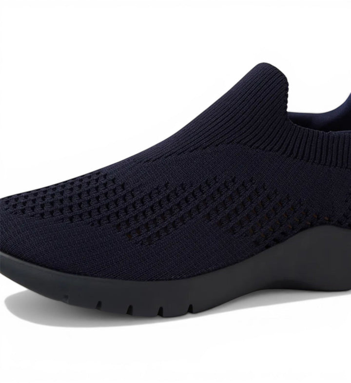House of Florian navy knit slip-on sneakers with perforated detailing and a flexible sole.