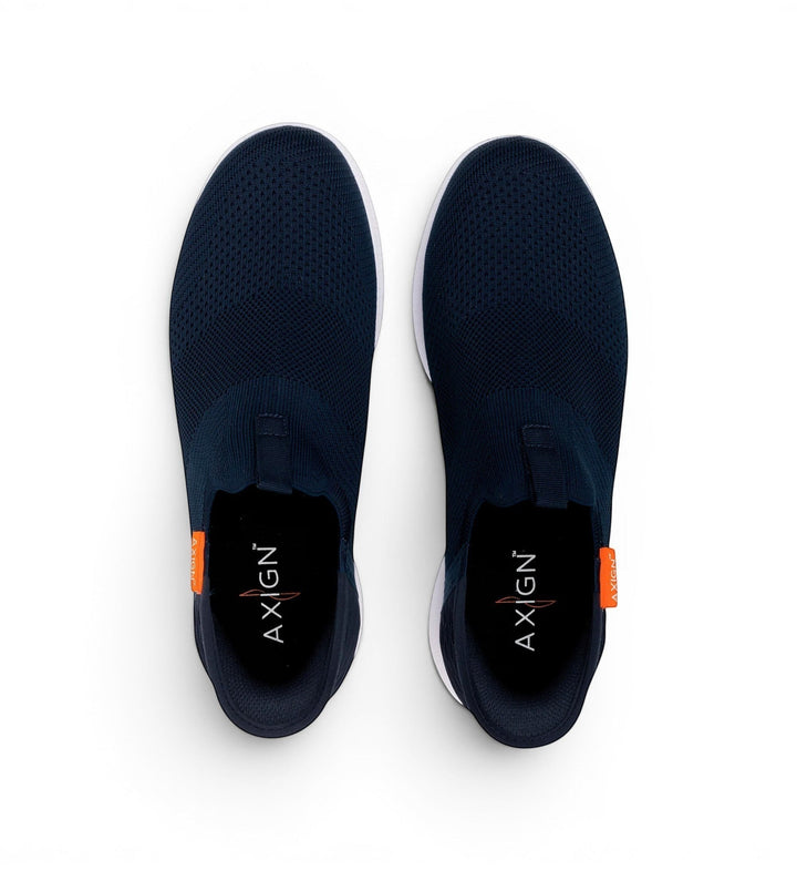 House of Florian navy blue knit slip-on sneakers with white soles and orange accent tags.