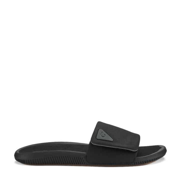 House of Florian Olukai Ulele Lanai Lava Rock black slide sandal with adjustable strap and textured sole.