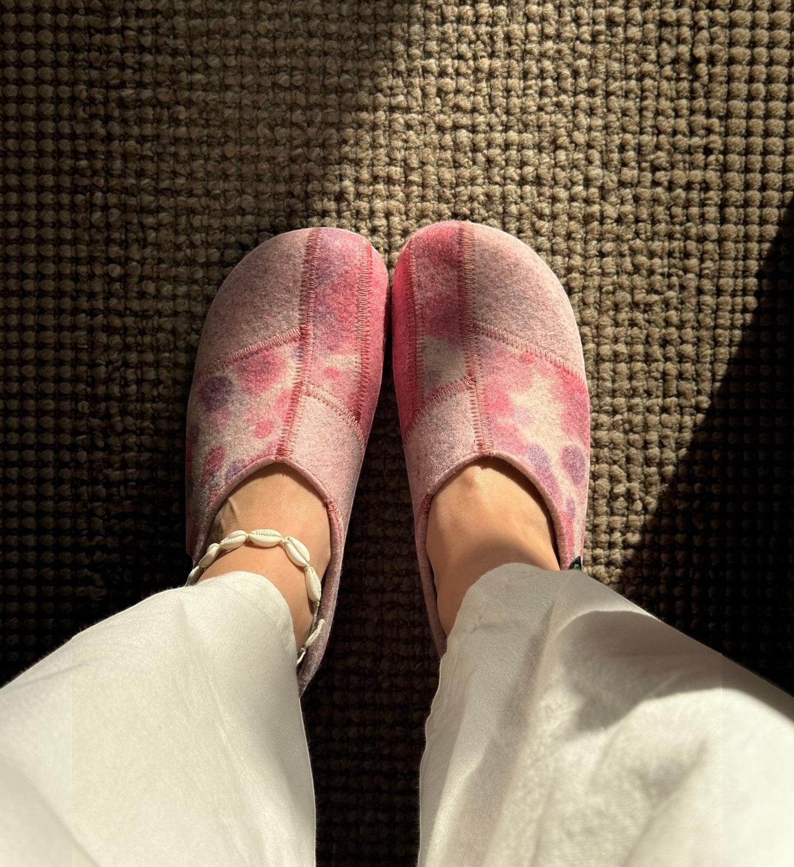 House of Florian Hilda pink bubble felt slippers with a tie-dye pattern worn on feet over a textured carpet