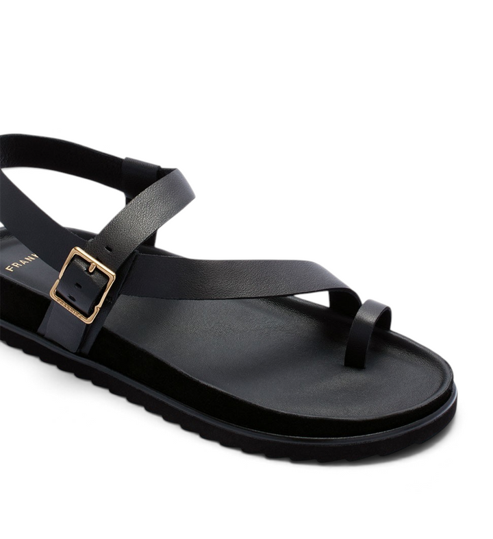 House of Florian Ren Black leather toe-loop sandal with an adjustable gold buckle strap and a comfortable flat sole.