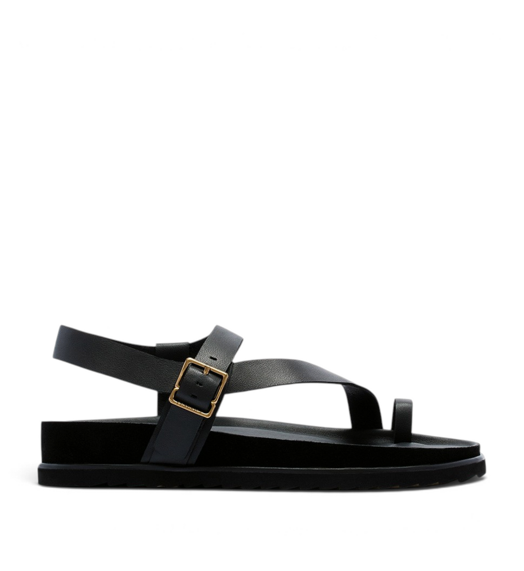 House of Florian Ren Black leather toe-loop sandals with an adjustable gold buckle strap and a flat black sole.