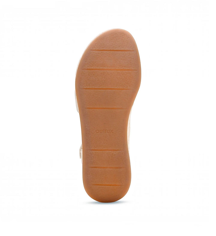 House of Florian Flora Champagne sandal showing the textured brown rubber outsole with horizontal tread patterns