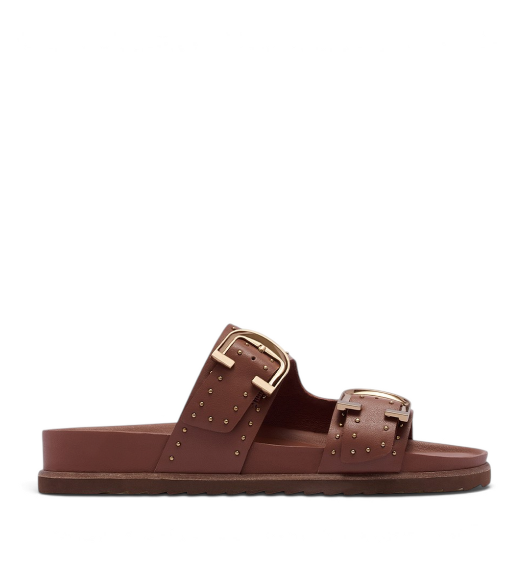 House of Florian Deon rich tan slide sandals featuring double straps, gold buckles, and decorative stud detailing.