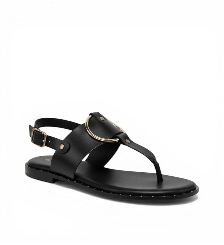 House of Florian Tegan black leather flat sandals with gold hardware and adjustable ankle strap.