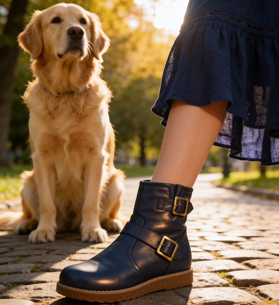 House of Florian Rilassare Temora Navy leather ankle boots with gold buckles and side strap detail.