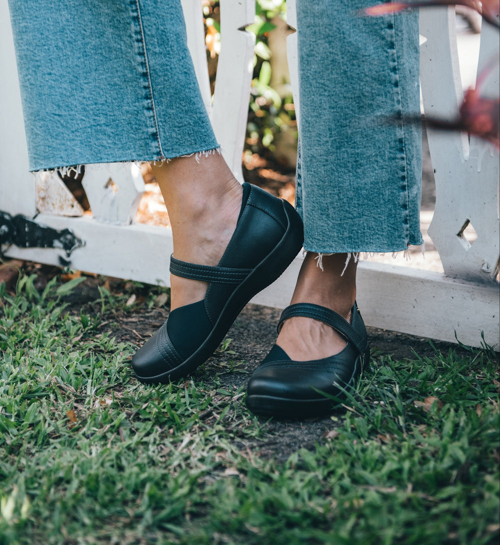House of Florian Timaru W black leather Mary Jane shoes with neoprene panels and adjustable strap, worn with cropped jeans.