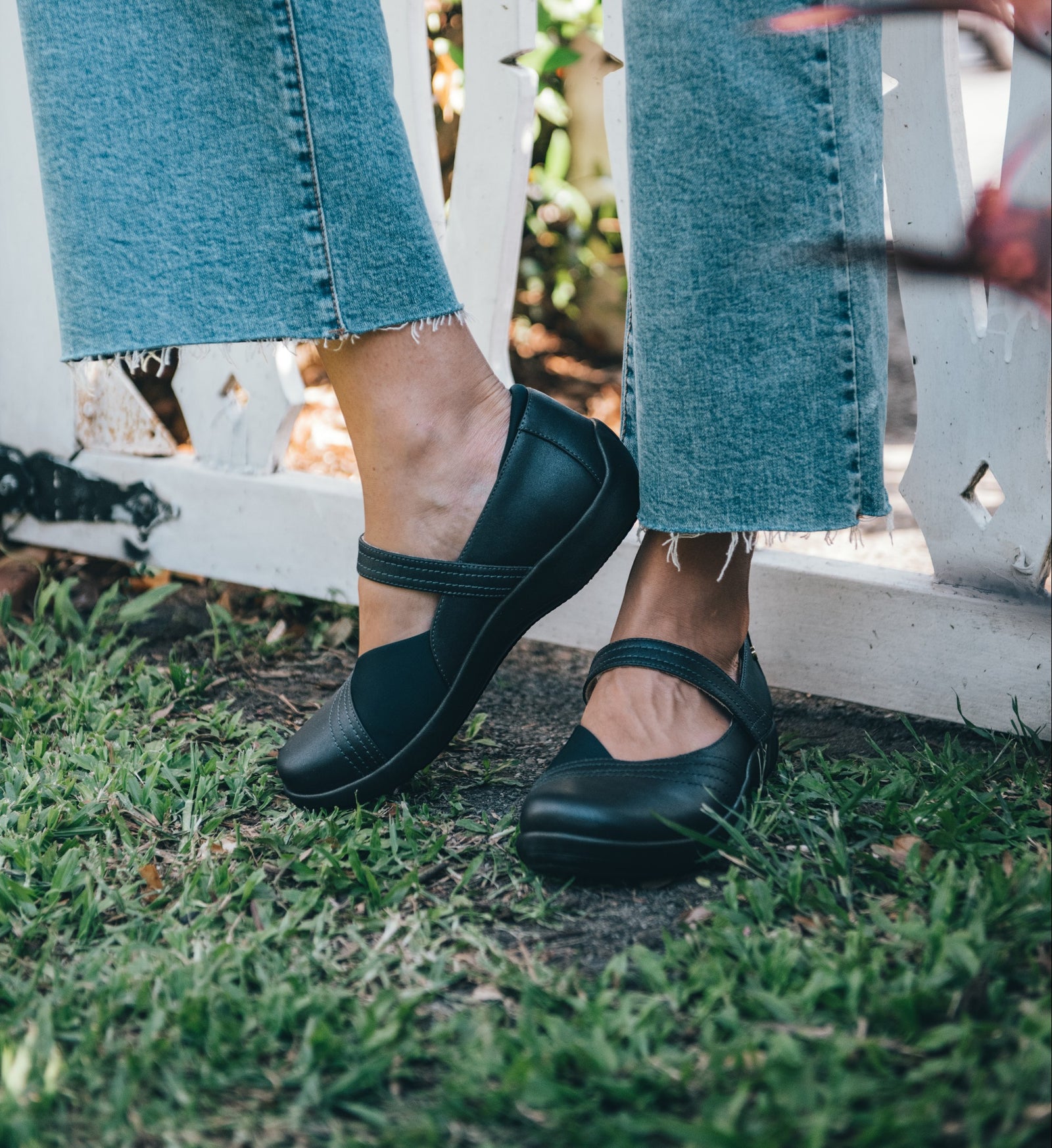 House of Florian Timaru W black leather Mary Jane shoes with neoprene panels and adjustable strap, worn with cropped jeans.