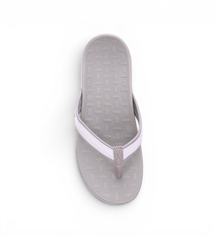 House of Florian Venture White flip-flops with a textured grey sole and white fabric straps.
