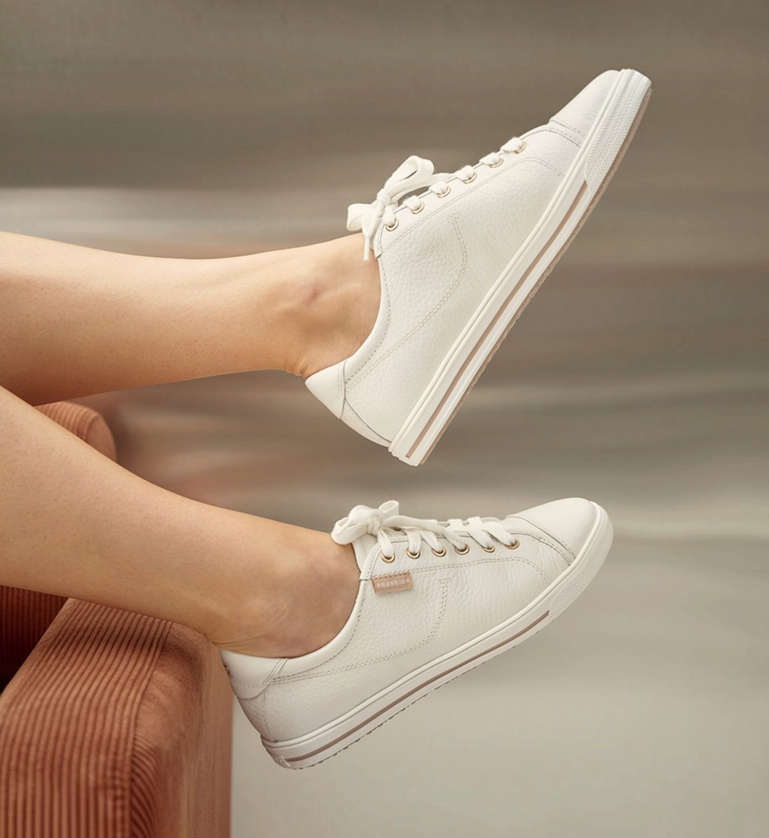 House of Florian Nat III white pebbled leather sneakers with lace-up closure and gold eyelets on a model
