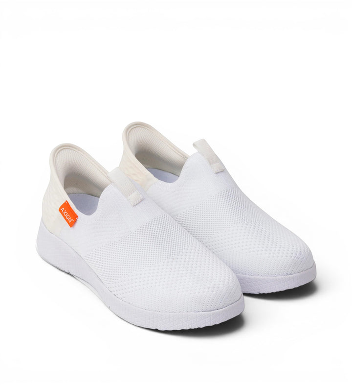 House of Florian white knit slip-on sneakers with elastic heel tab and orange logo tag.
